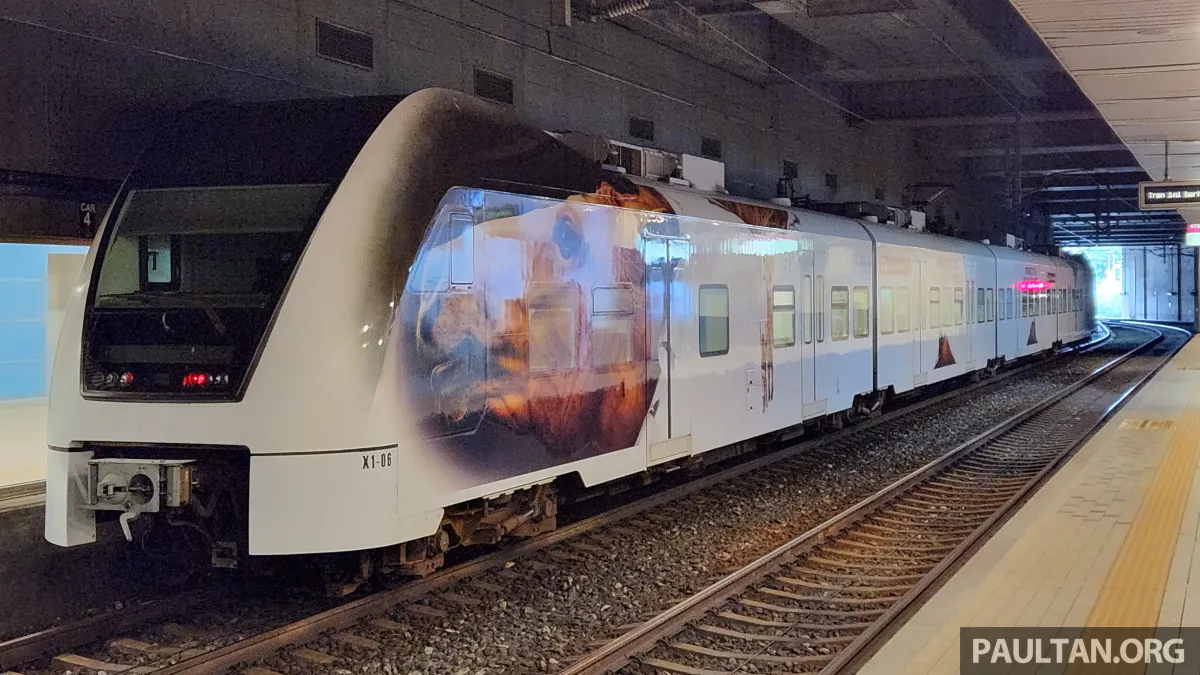 An airport rail platform with a passenger train