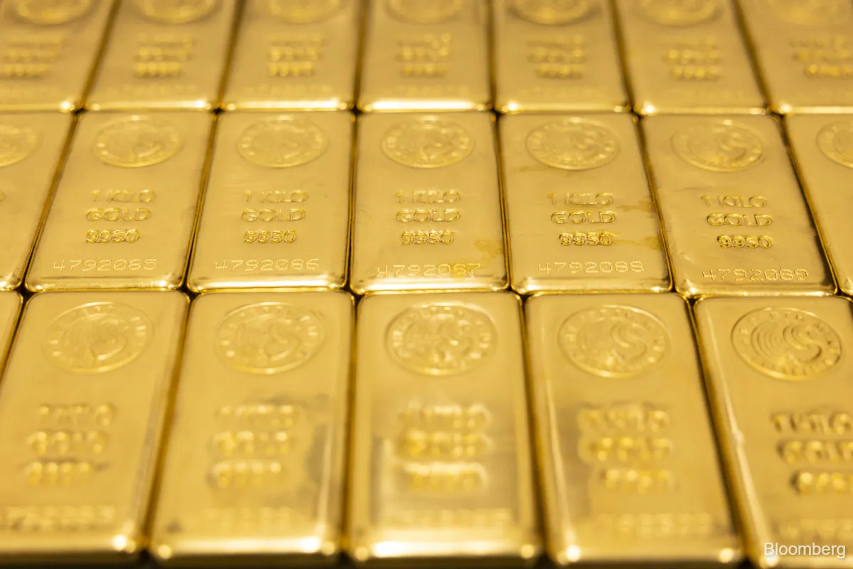Gold and silver bullion bars on a neutral background