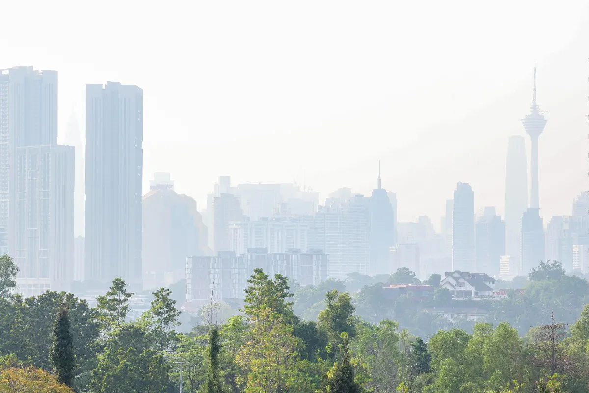 Factory buildings beneath a hazy sky