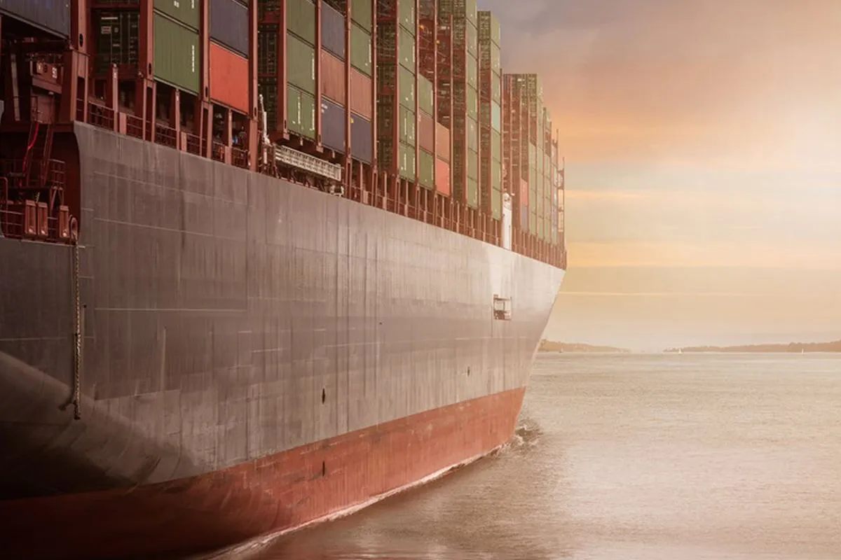 Cargo ships berthed at a port beside container cranes