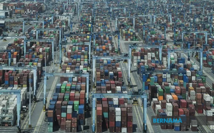 Shipping containers and cargo cranes at a port terminal