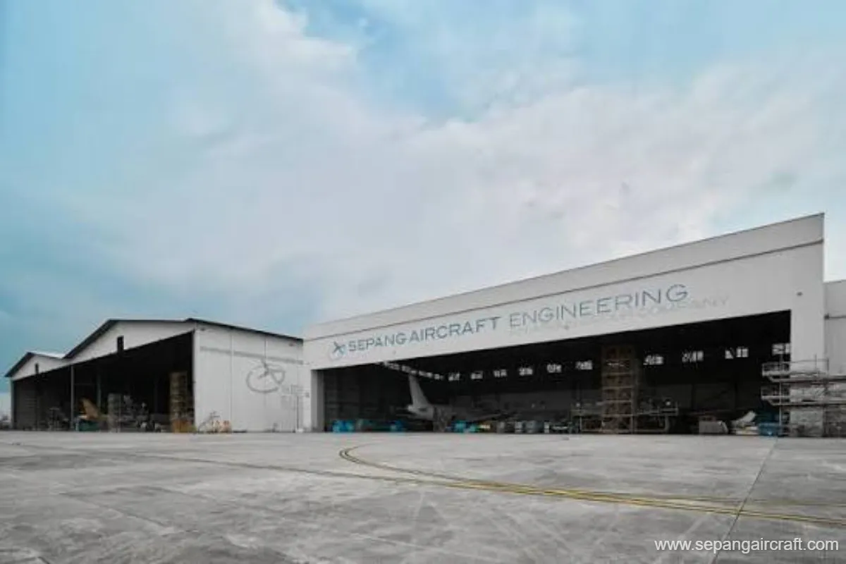 Aircraft undergoing maintenance inside an aviation hangar