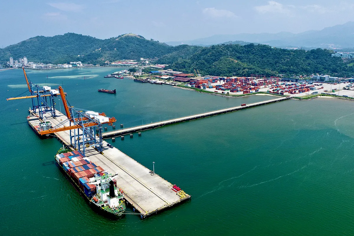 Shipping containers, cranes and trailers at a container terminal