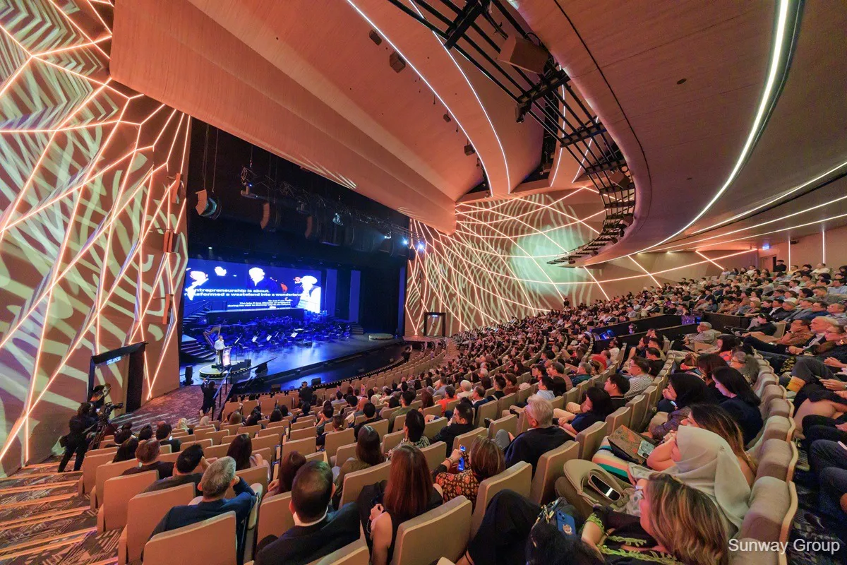 Illustration of a theatre auditorium with rows of seats facing a stage