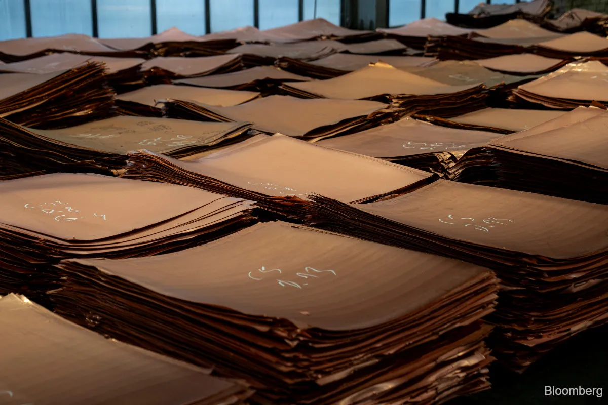 Copper coils stacked in an industrial warehouse