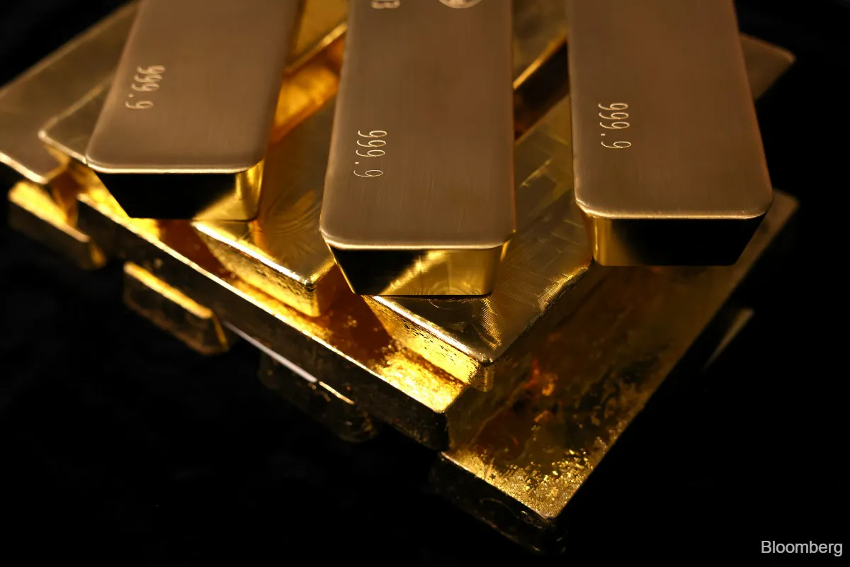 Gold bars arranged on a dark surface