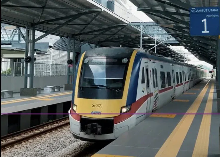 Commuter train beside a railway station platform